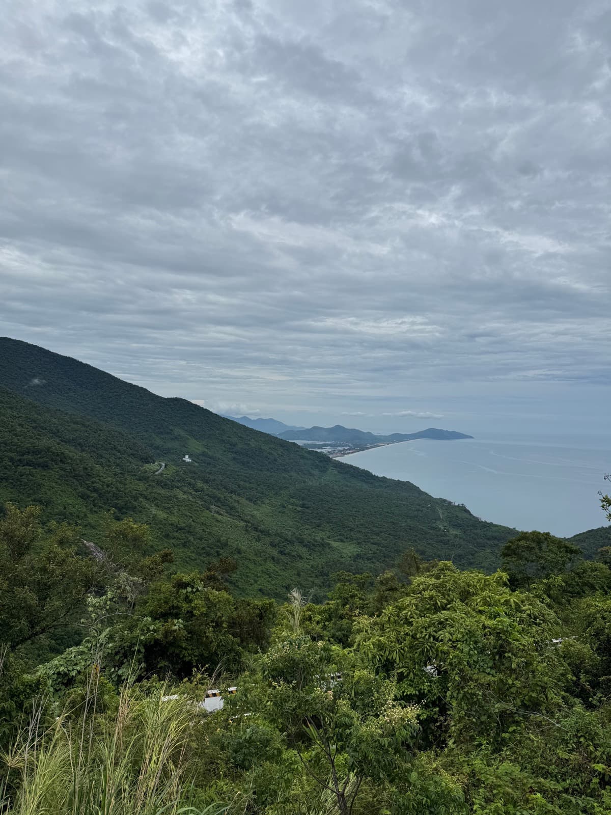View from the Hai Van summit over the coastline curving toward Lang Co